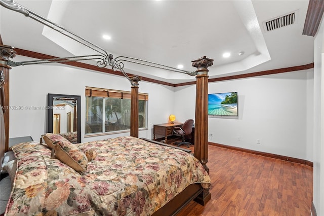 bedroom with baseboards, recessed lighting, visible vents, ornate columns, and wood finished floors