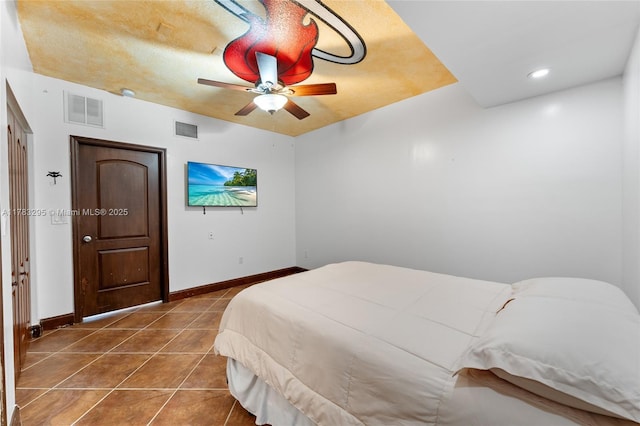 bedroom featuring visible vents, baseboards, a ceiling fan, and tile patterned flooring