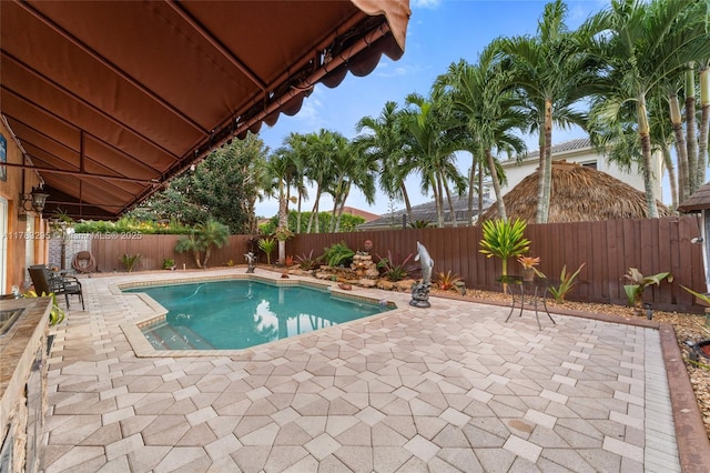 view of swimming pool featuring a patio, a fenced backyard, and a fenced in pool