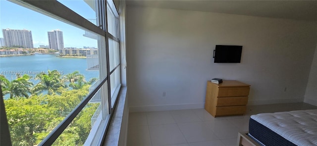 2801 NE 183rd St Unit 714W, Aventura, FL 33160 - bedroom featuring a water view, baseboards, a view of city, and light tile patterned floors
