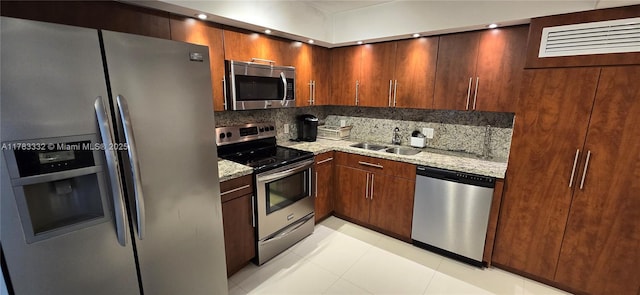 2801 NE 183rd St Unit 714W, Aventura, FL 33160 - kitchen with appliances with stainless steel finishes, a sink, tasteful backsplash, and light stone counters