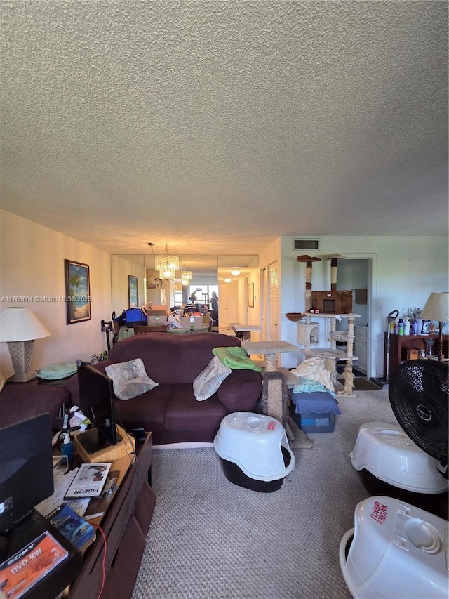carpeted living area featuring a textured ceiling, an inviting chandelier, and visible vents