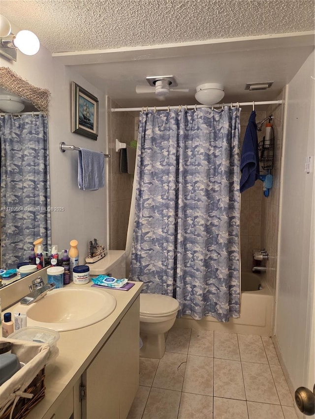 full bathroom featuring vanity, tile patterned flooring, a textured ceiling, toilet, and shower / bath combo with shower curtain