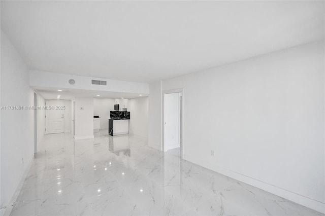 unfurnished living room with visible vents, baseboards, recessed lighting, and marble finish floor