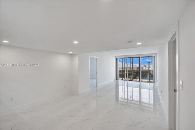 3625 N Country Club Dr Unit 2310, Aventura, FL 33180 - unfurnished room featuring recessed lighting, light marble finish flooring, and baseboards