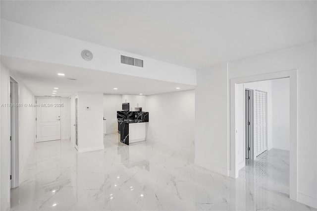 unfurnished living room featuring marble finish floor, baseboards, visible vents, and recessed lighting