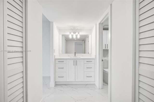 3625 N Country Club Dr Unit 2310, Aventura, FL 33180 - bathroom with a closet, marble finish floors, vanity, a chandelier, and toilet