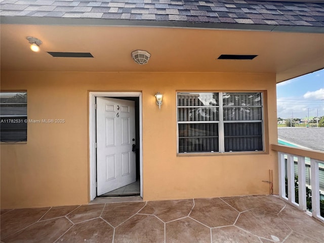 410 SE 4th Ave Unit 6, Hallandale Beach, FL 33009 - doorway to property featuring stucco siding and a shingled roof