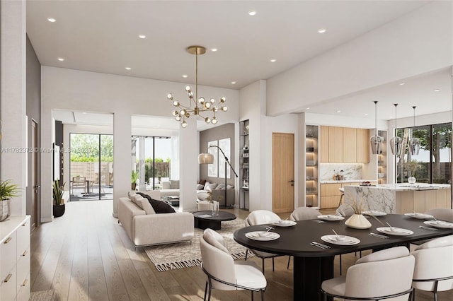 dining room featuring recessed lighting, plenty of natural light, a notable chandelier, and light wood-type flooring
