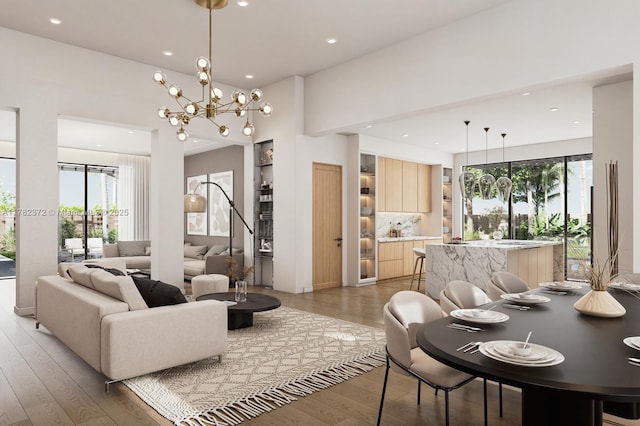 living room with light wood finished floors, an inviting chandelier, and recessed lighting