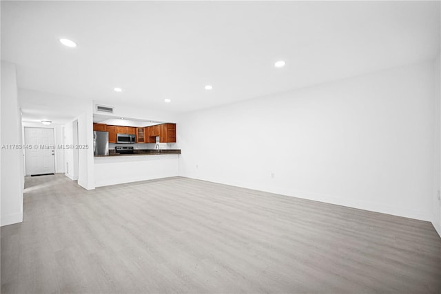1845 W 73rd Pl Unit 1845, Hialeah, FL 33014 - unfurnished living room with wood finished floors, recessed lighting, and baseboards