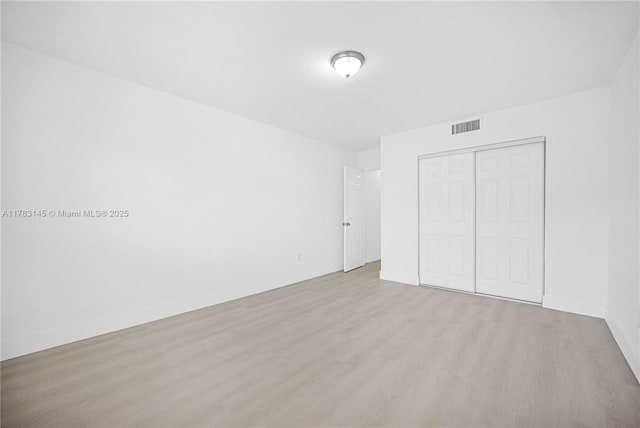 1845 W 73rd Pl Unit 1845, Hialeah, FL 33014 - unfurnished bedroom featuring wood finished floors, a closet, and baseboards