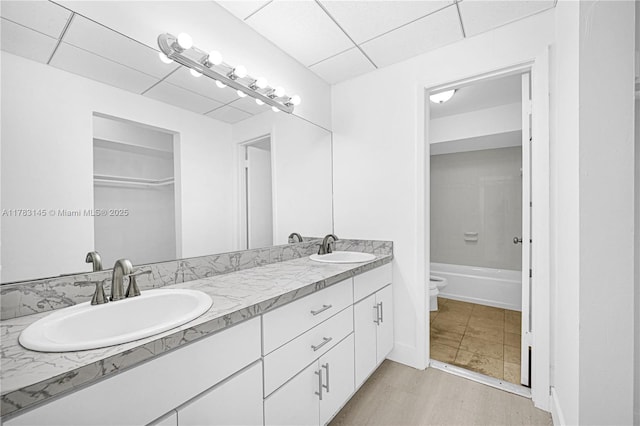 1845 W 73rd Pl Unit 1845, Hialeah, FL 33014 - bathroom featuring toilet, double vanity, and a drop ceiling