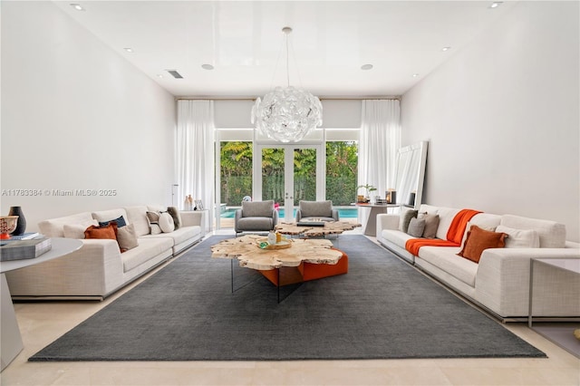 living room featuring visible vents and an inviting chandelier