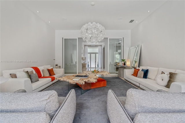 carpeted living area featuring visible vents, recessed lighting, and an inviting chandelier