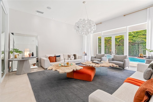 tiled living area with french doors, an inviting chandelier, a high ceiling, and visible vents