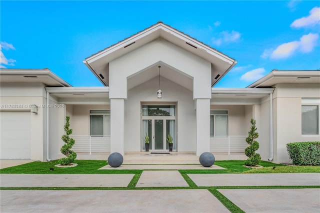 back of house with french doors and stucco siding