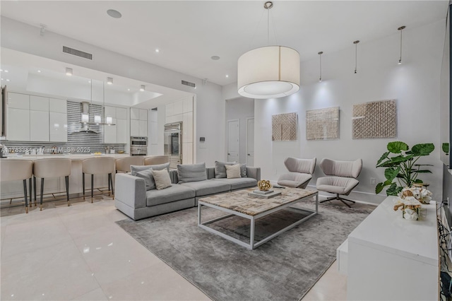living area featuring recessed lighting, light tile patterned floors, and visible vents