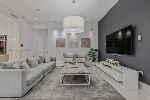 living area with visible vents and baseboards