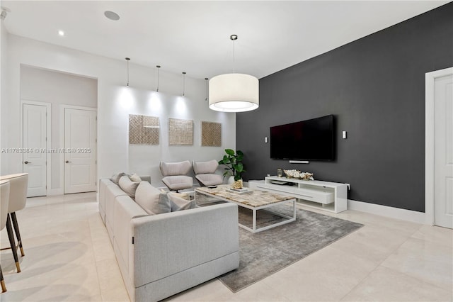 living room with light tile patterned floors and baseboards