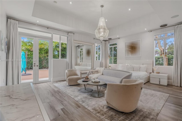 sitting room featuring french doors, wood finished floors, a notable chandelier, and recessed lighting