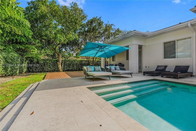 view of pool featuring outdoor lounge area, a patio, and a fenced in pool