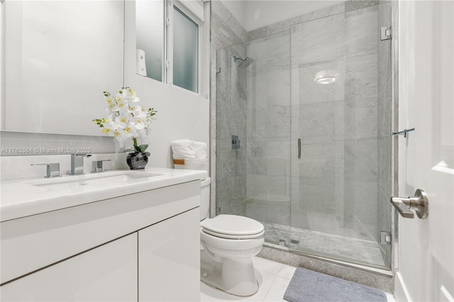 bathroom featuring a shower stall, tile patterned flooring, vanity, and toilet