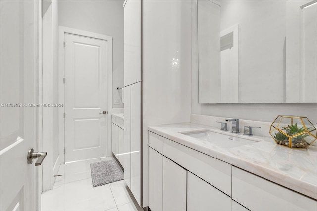 bathroom with tile patterned floors and vanity