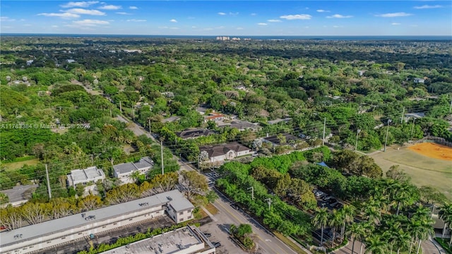 birds eye view of property with a wooded view