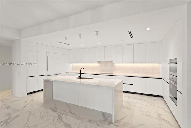160 Isle Of Venice Dr Unit 403, Fort Lauderdale, FL 33301 - kitchen with modern cabinets, stainless steel oven, white cabinetry, marble finish floor, and a sink