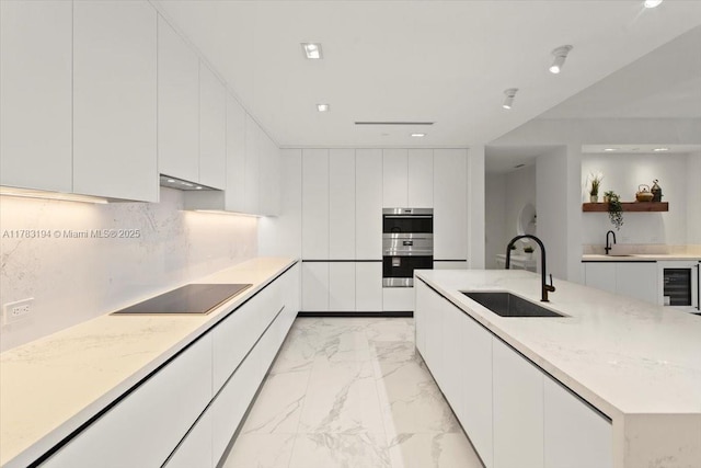 160 Isle Of Venice Dr Unit 403, Fort Lauderdale, FL 33301 - kitchen featuring a sink, marble finish floor, black electric cooktop, and modern cabinets