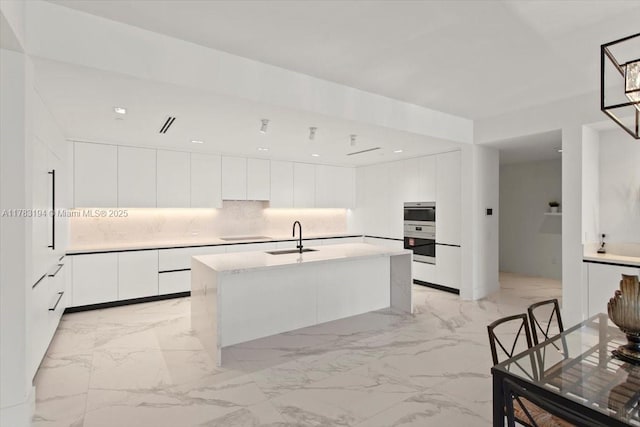 160 Isle Of Venice Dr Unit 403, Fort Lauderdale, FL 33301 - kitchen with light countertops, white cabinetry, modern cabinets, marble finish floor, and a sink