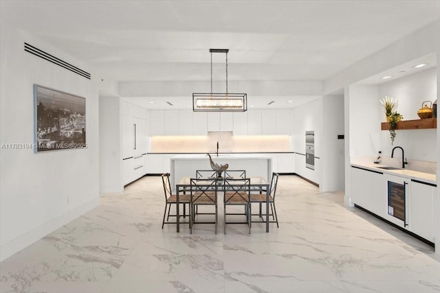 160 Isle Of Venice Dr Unit 403, Fort Lauderdale, FL 33301 - dining area featuring marble finish floor, baseboards, beverage cooler, and recessed lighting