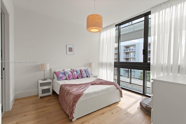 160 Isle Of Venice Dr Unit 403, Fort Lauderdale, FL 33301 - bedroom with access to outside, baseboards, light wood-type flooring, and floor to ceiling windows