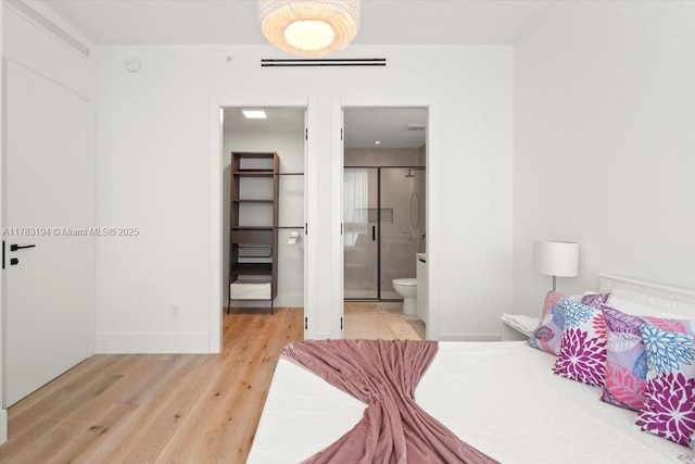 160 Isle Of Venice Dr Unit 403, Fort Lauderdale, FL 33301 - bedroom with visible vents, baseboards, a walk in closet, connected bathroom, and light wood-style flooring