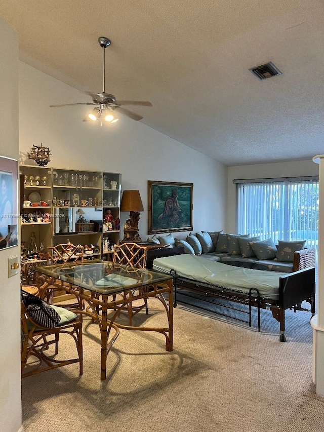 living room featuring visible vents, carpet, vaulted ceiling, and a textured ceiling