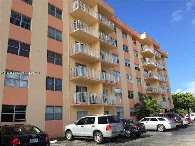16465 NE 22nd Ave Unit 205, North Miami Beach, FL 33160 - view of building exterior featuring uncovered parking