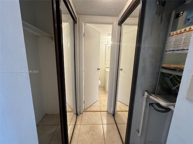 16465 NE 22nd Ave Unit 205, North Miami Beach, FL 33160 - corridor featuring light tile patterned floors and a textured ceiling