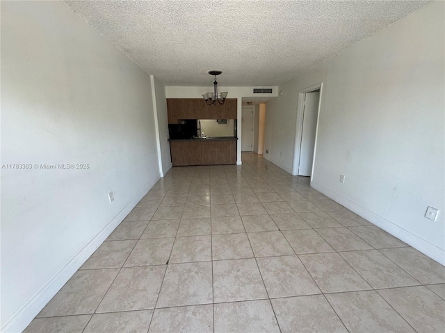 16465 NE 22nd Ave Unit 205, North Miami Beach, FL 33160 - spare room with a textured ceiling, light tile patterned floors, a notable chandelier, and visible vents