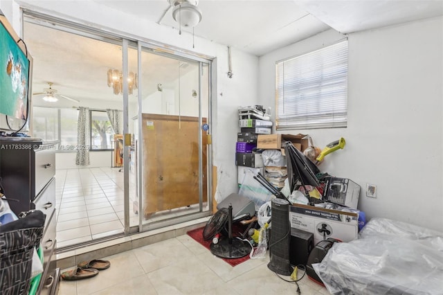 miscellaneous room featuring tile patterned floors, a healthy amount of sunlight, and a ceiling fan