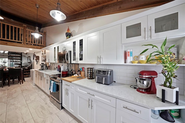 kitchen with appliances with stainless steel finishes, marble finish floor, white cabinetry, and wooden ceiling