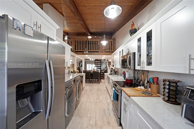 kitchen featuring washer / clothes dryer, white cabinets, glass insert cabinets, wooden ceiling, and appliances with stainless steel finishes