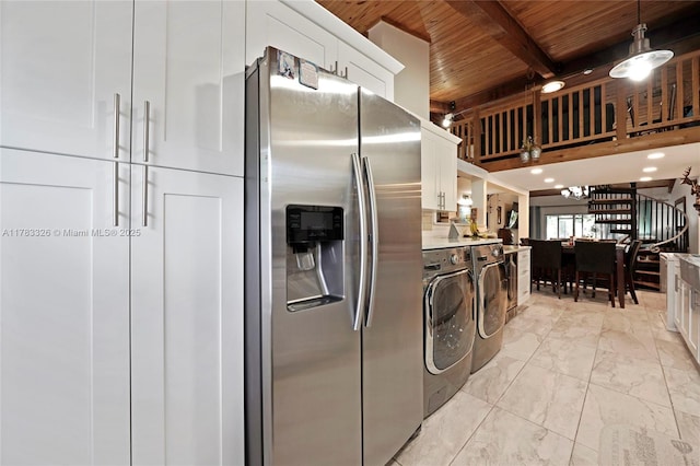 laundry room with wood ceiling, marble finish floor, and washing machine and dryer