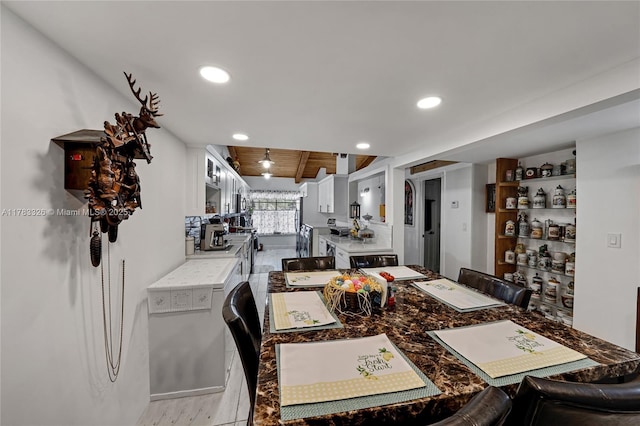 dining space with wood finished floors and recessed lighting