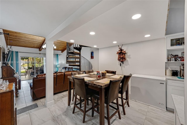 dining room featuring recessed lighting, marble finish floor, and stairs