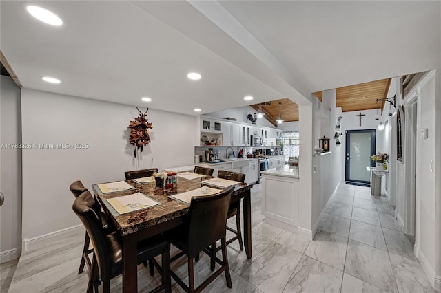 dining room with marble finish floor, baseboards, and recessed lighting