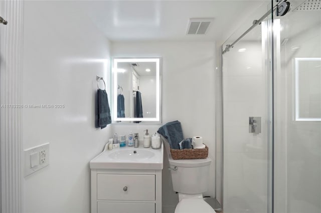 full bath featuring visible vents, toilet, a stall shower, and vanity