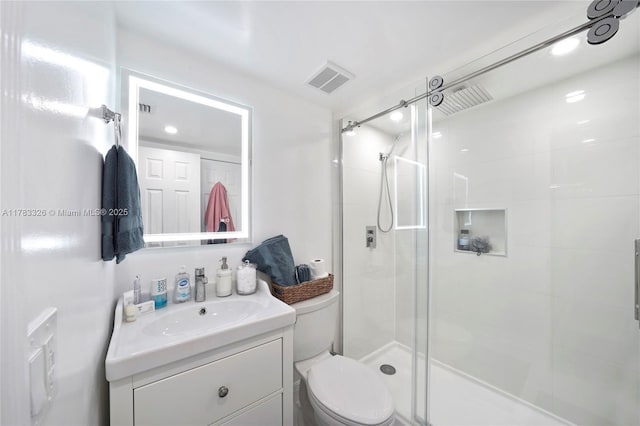 full bath featuring visible vents, toilet, a stall shower, and vanity