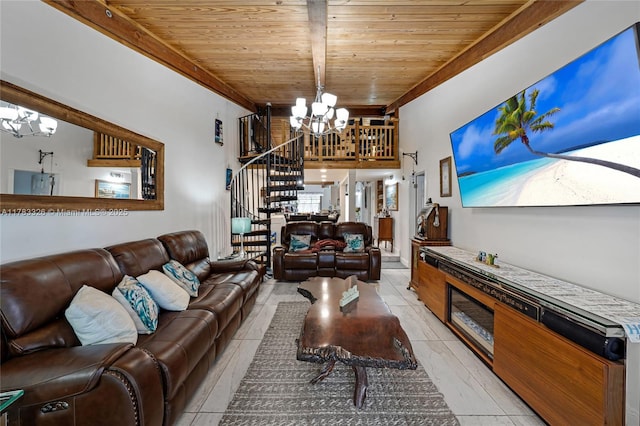 living area featuring beam ceiling, wooden ceiling, a chandelier, and stairs