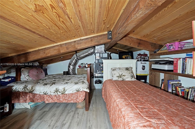 bedroom with vaulted ceiling, wooden ceiling, and wood finished floors